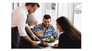 Two diners being served at one of the most romantic restaurants in town, The Shipwright's Daughter.