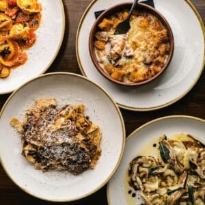 Plates full of fresh Italian food at Via Emilia in Downtown Mystic