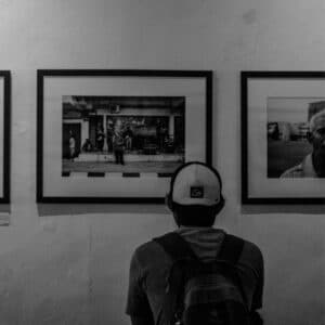 Black and White Photo of Person Admiring Art