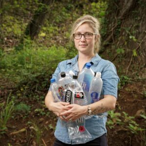 Elizabeth holding up plastic bottle to inspire ocean conservation