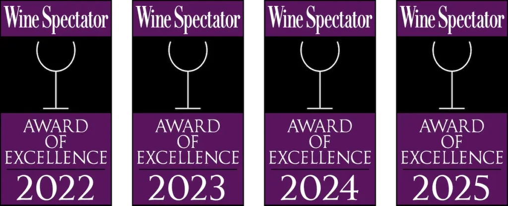 Four Wine Spectator Award of Excellence emblems for the years 2022, 2023, 2024, and 2025.
