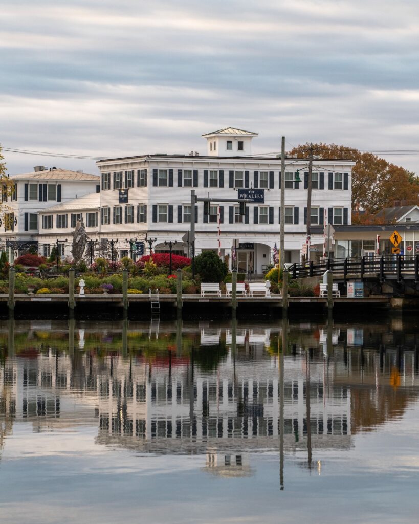 The Whaler's Inn in Mystic, Connecticut, reflecting in the calm waters of the Mystic River.