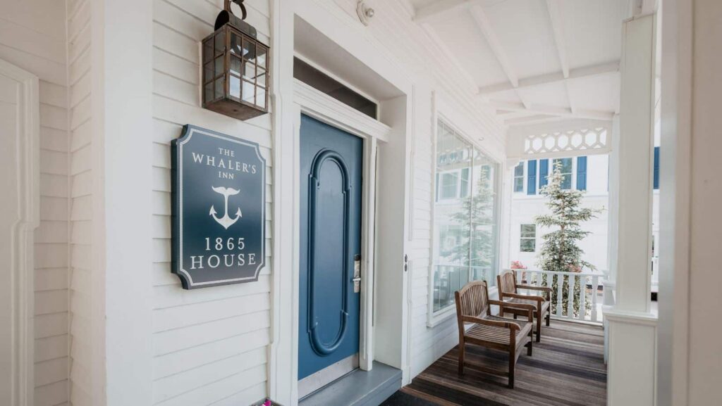 The charming front porch and blue entry door of The Whaler's Inn 1865 House in Mystic, Connecticut.