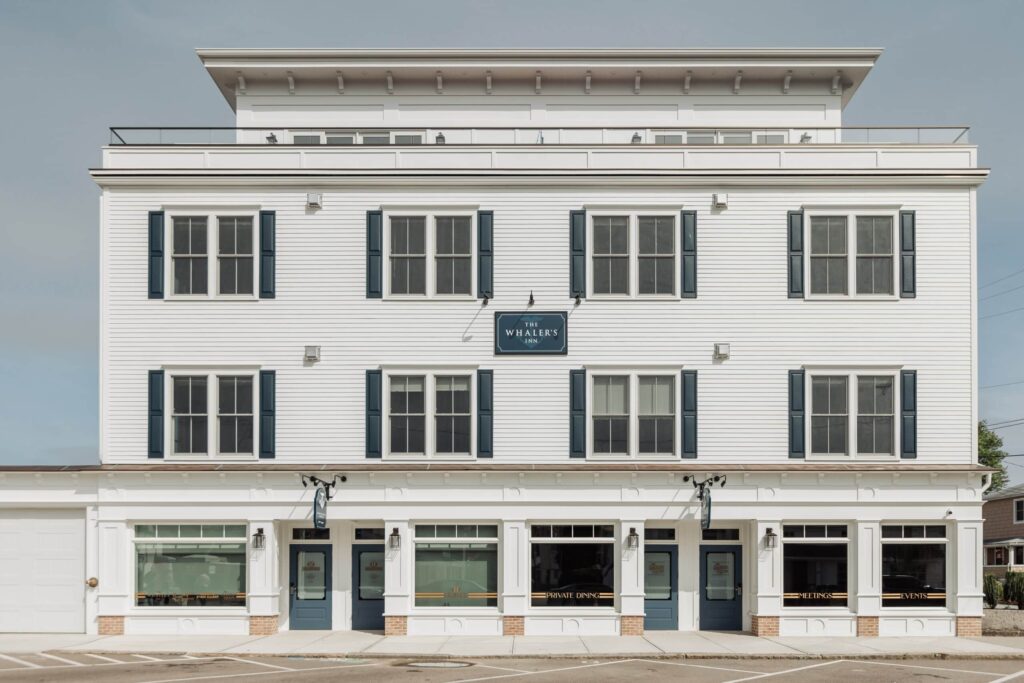 Exterior view of The Whaler’s Inn, a boutique hotel featuring classic white siding and blue shutters.