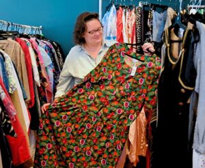 Women holding up dress while sustainably shopping