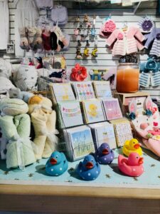 Baby shower cards and bath toys on the counter of children's store, Mara Luna. 