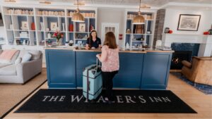 Hospitality positions available in Mystic, Front Desk Staff greeting hotel guest