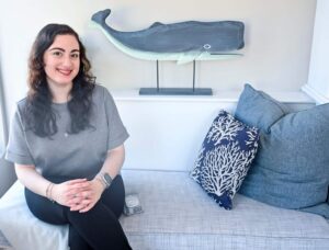 Our bilingual admin assistant at The Whaler's Inn posing on couch